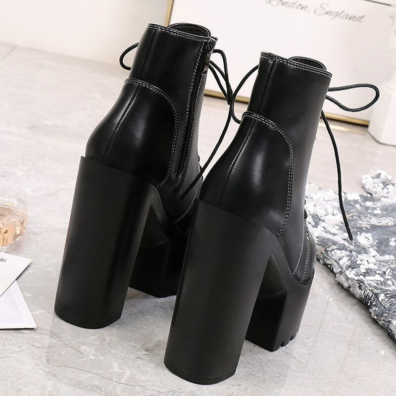 Black high heel ankle boots with a square heel and lace-up detail, perfect for goth outfits and versatile styling.