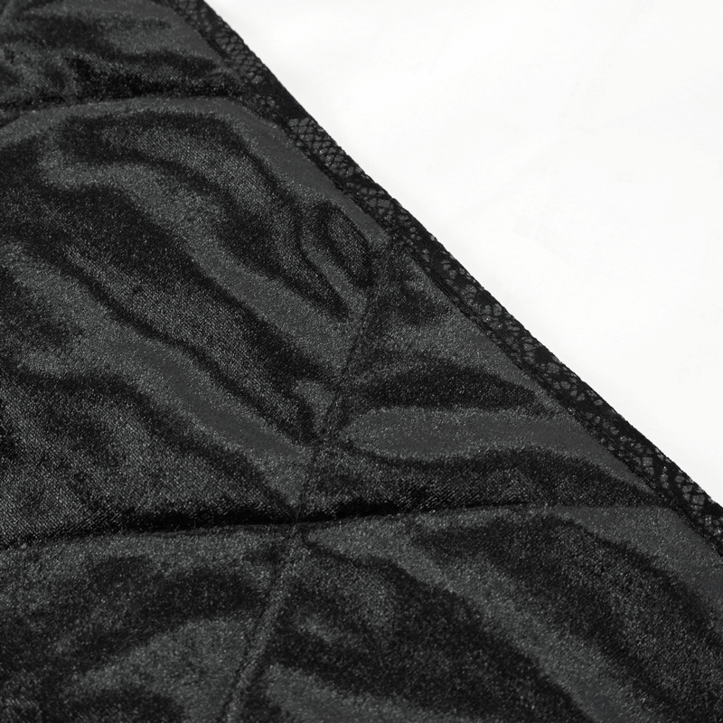 Close-up of the soft black fabric of a 2-in-1 cushion blanket with gothic style baroque ornaments.