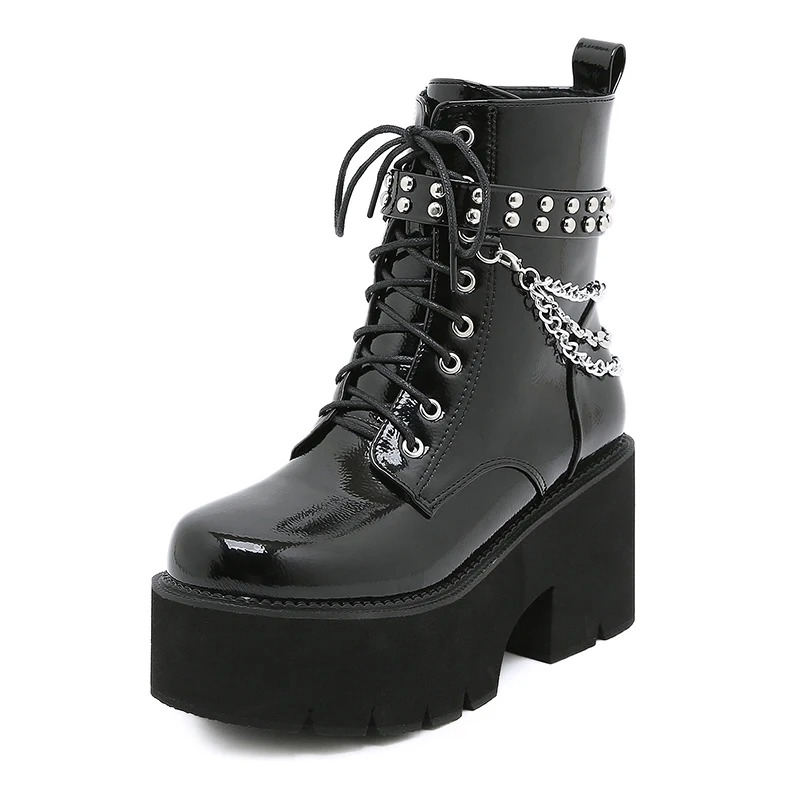 Women's black patent leather motorcycle ankle boots with metal chain detail and chunky platform sole.