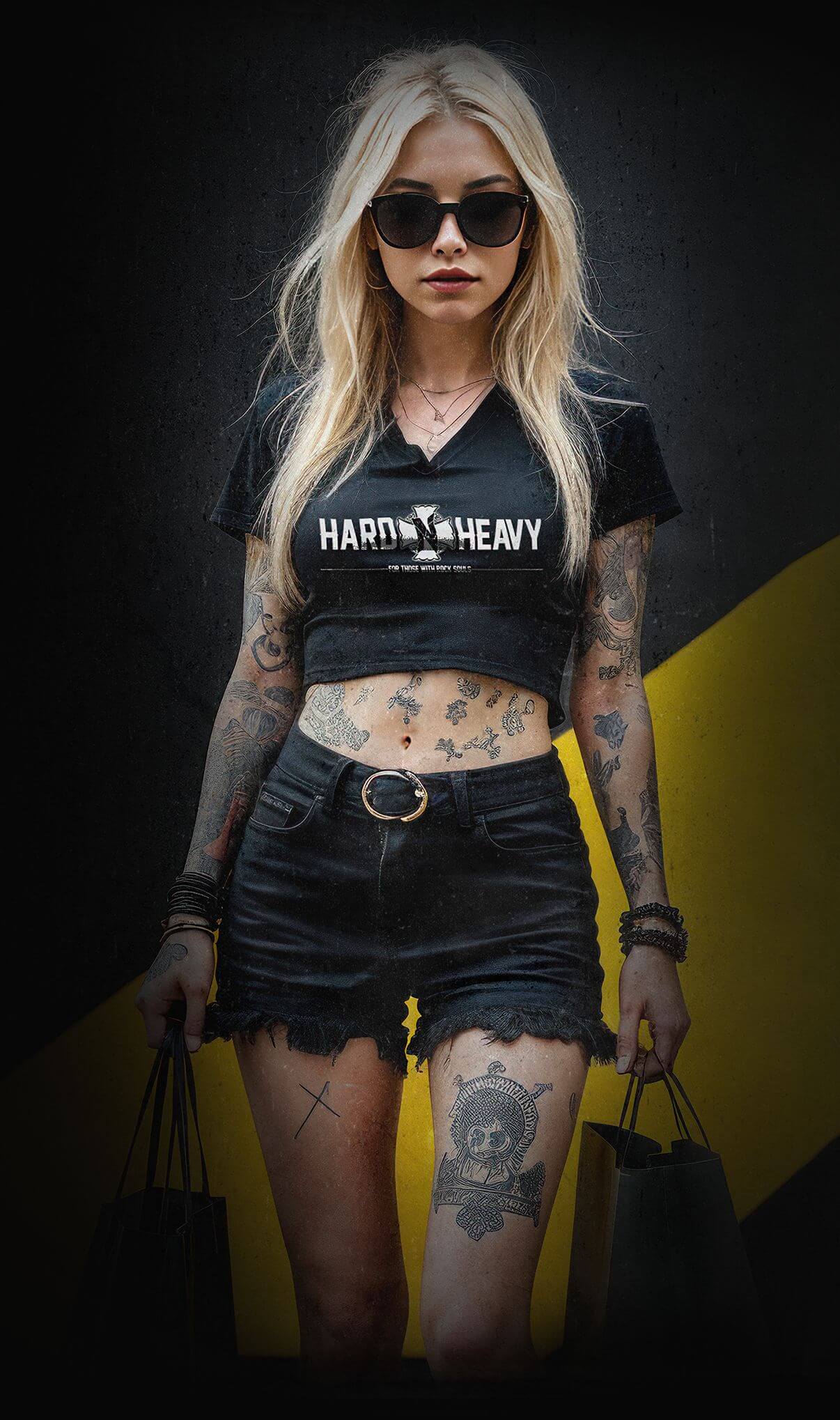 Two stylish women wearing HARD'N'HEAVY clothing, holding shopping bags, showcasing alternative fashion