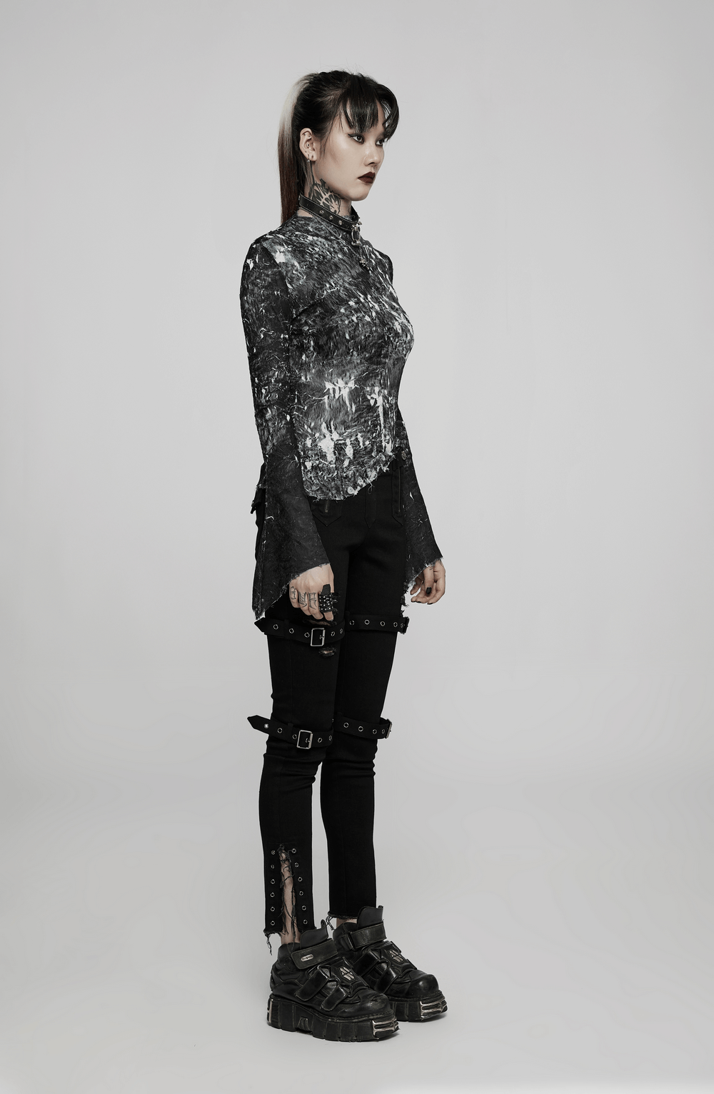 Model showcasing the Abstract Marble Gothic Fitted Top with long sleeves and stylish gothic trousers.