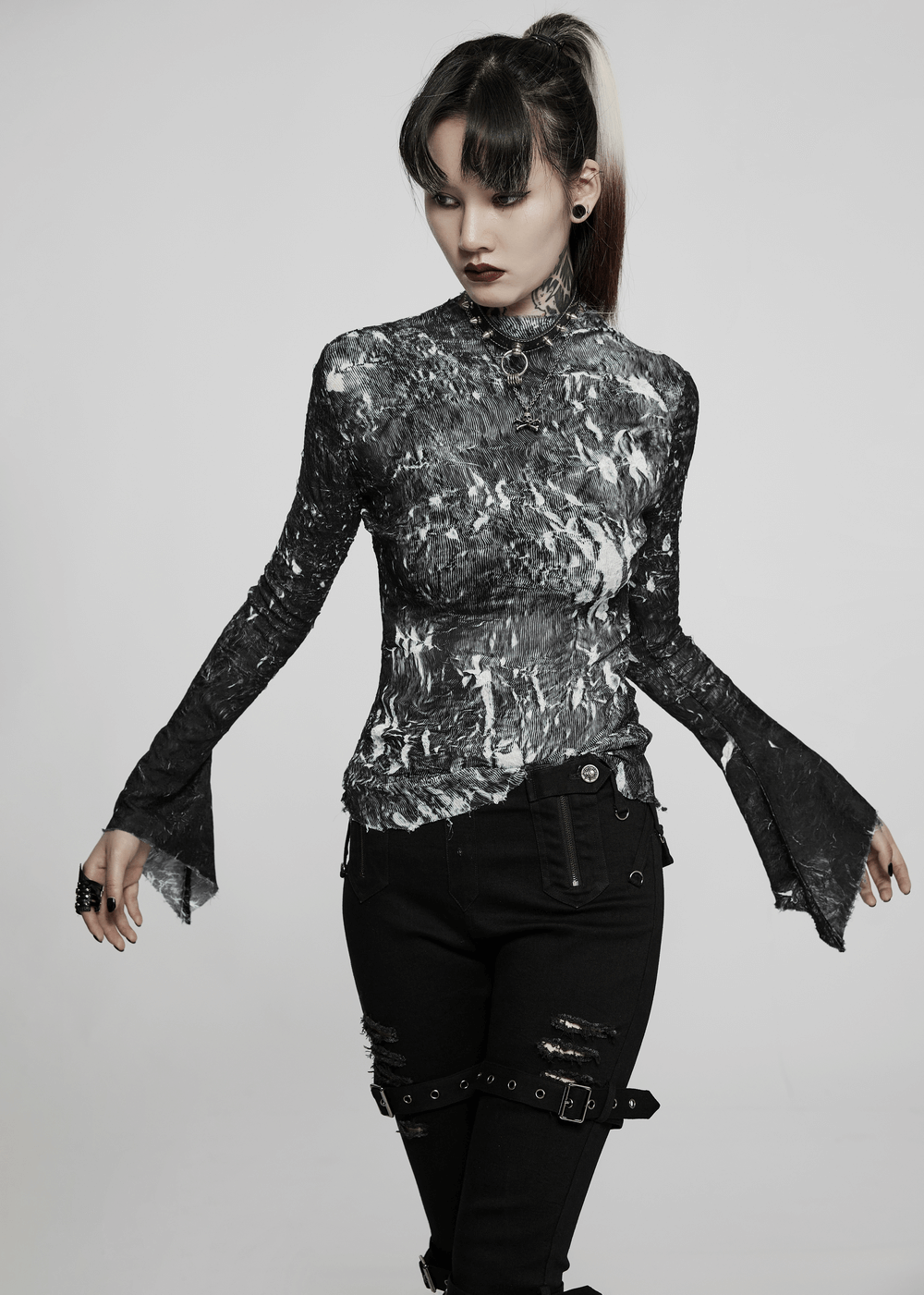 Model showcasing an Abstract Marble Gothic Fitted Top with long sleeves and unique marble texture.
