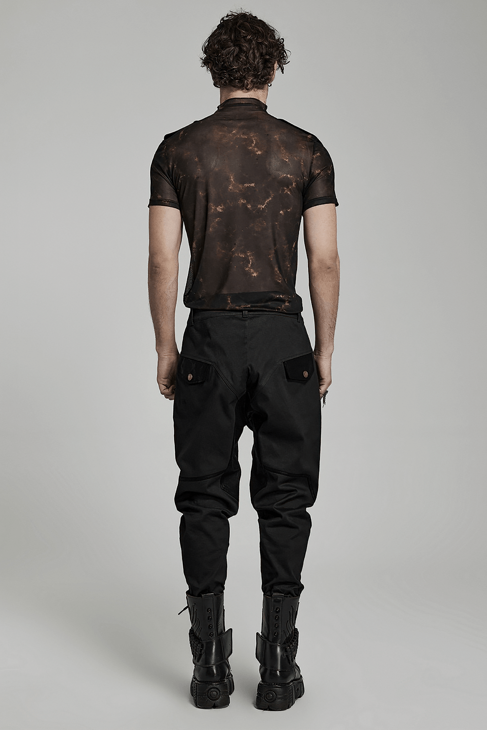 Back view of man wearing Abstract Print Stretch Mesh Tee and black pants, highlighting 3D lace shoulder details.