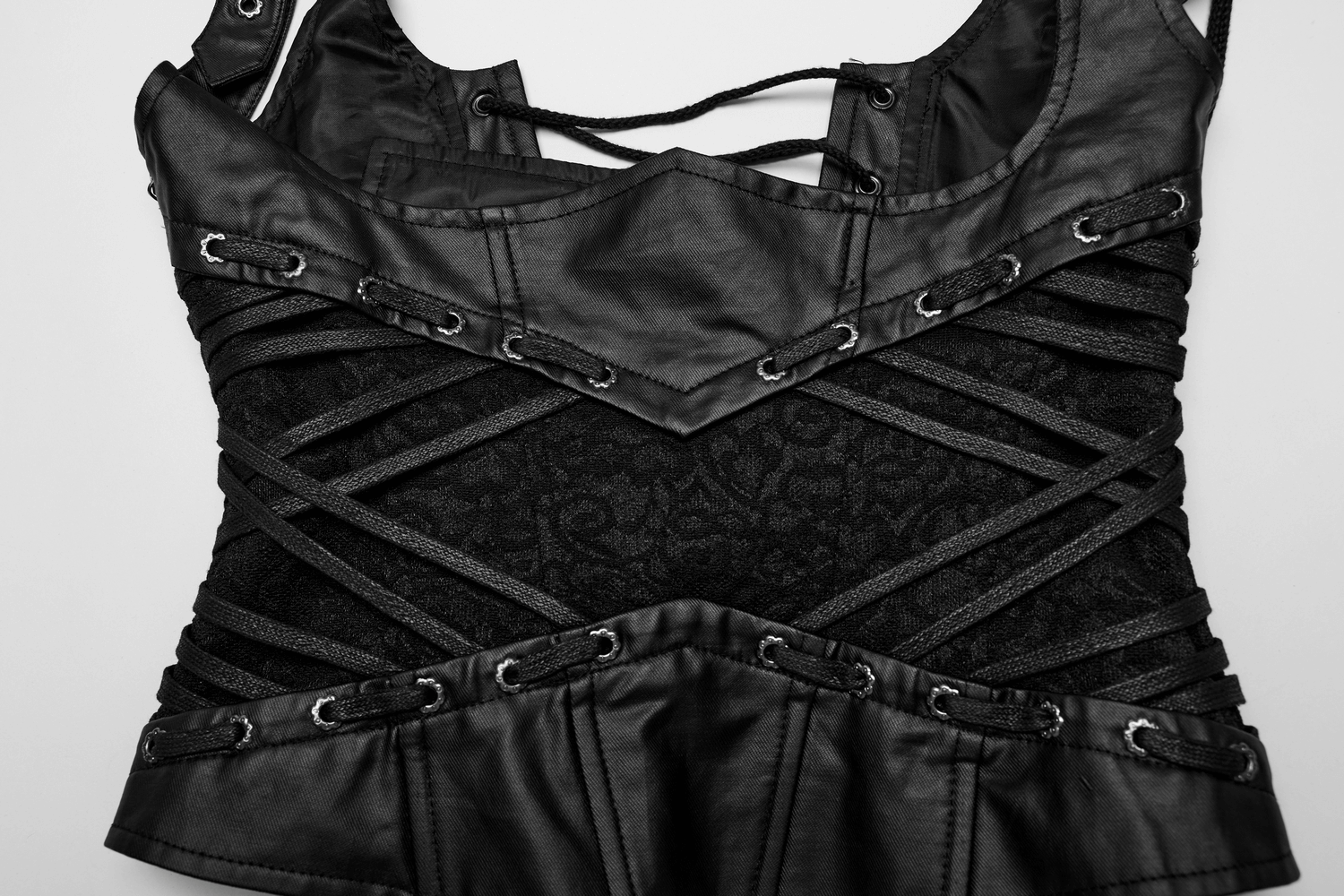 Close-up of adjustable black gothic lace-up corset with intricate detailing and sleek design.