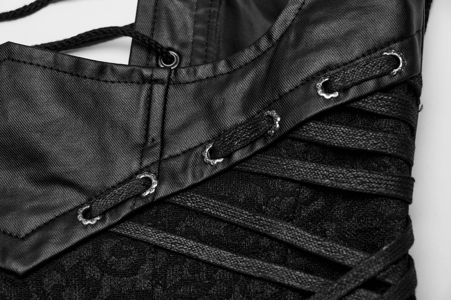 Close-up of adjustable black gothic lace-up corset detailing with woven fabric and stylish satin finish.