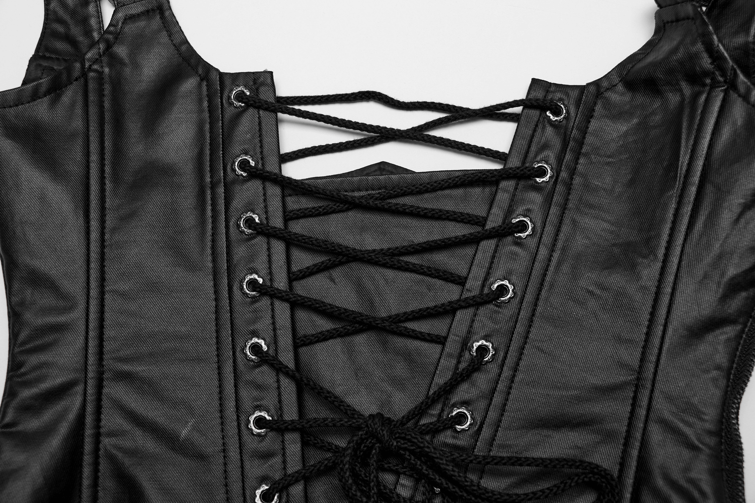 Close-up of adjustable black lace-up corset with intricate detailing and straps for a gothic look.