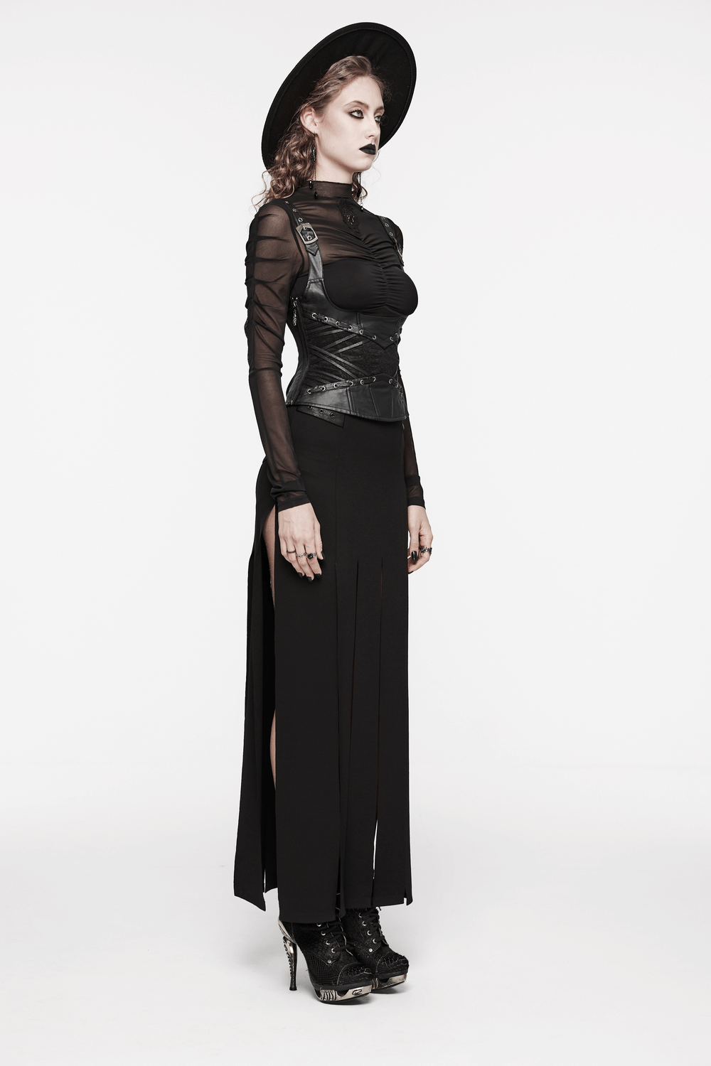Gothic model showcasing adjustable strappy black corset with a sleek skirt and hat, perfect for a dark, edgy look.