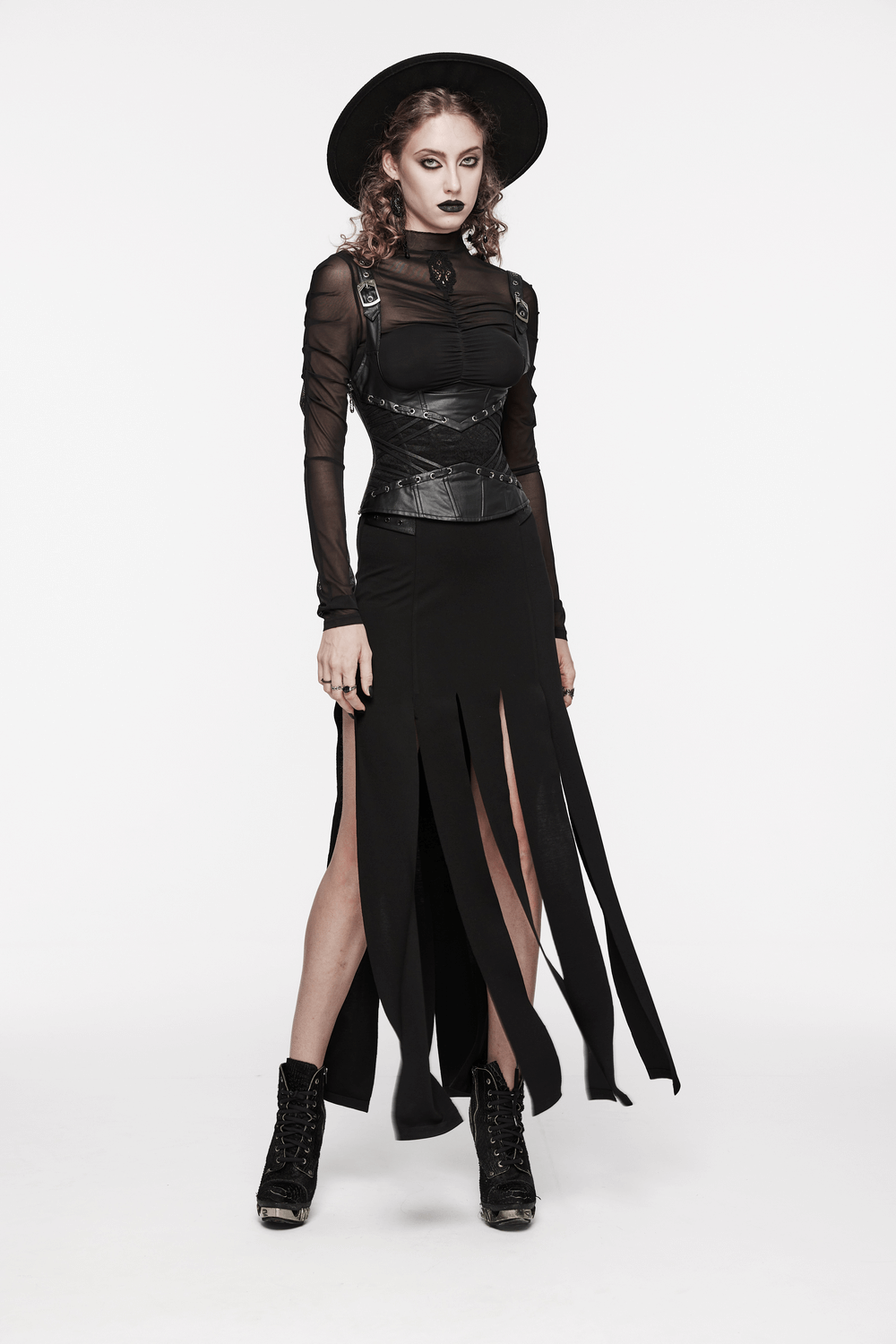 Model wearing a gothic black outfit with a lace-up corset and stylish hat, showcasing an edgy look.