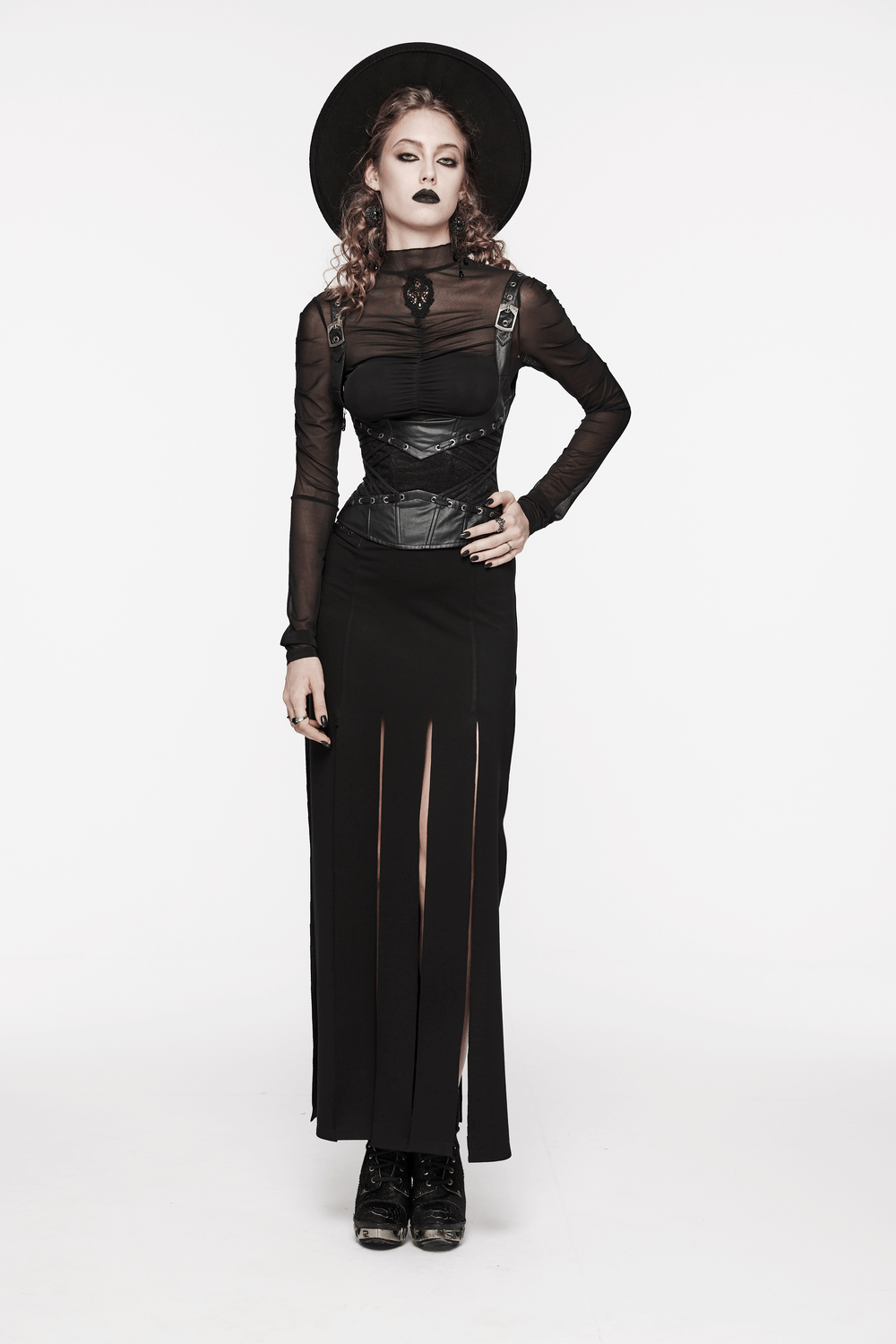 Model showcasing goth style with black adjustable corset, long skirt, and hat for an edgy, dark fashion statement.