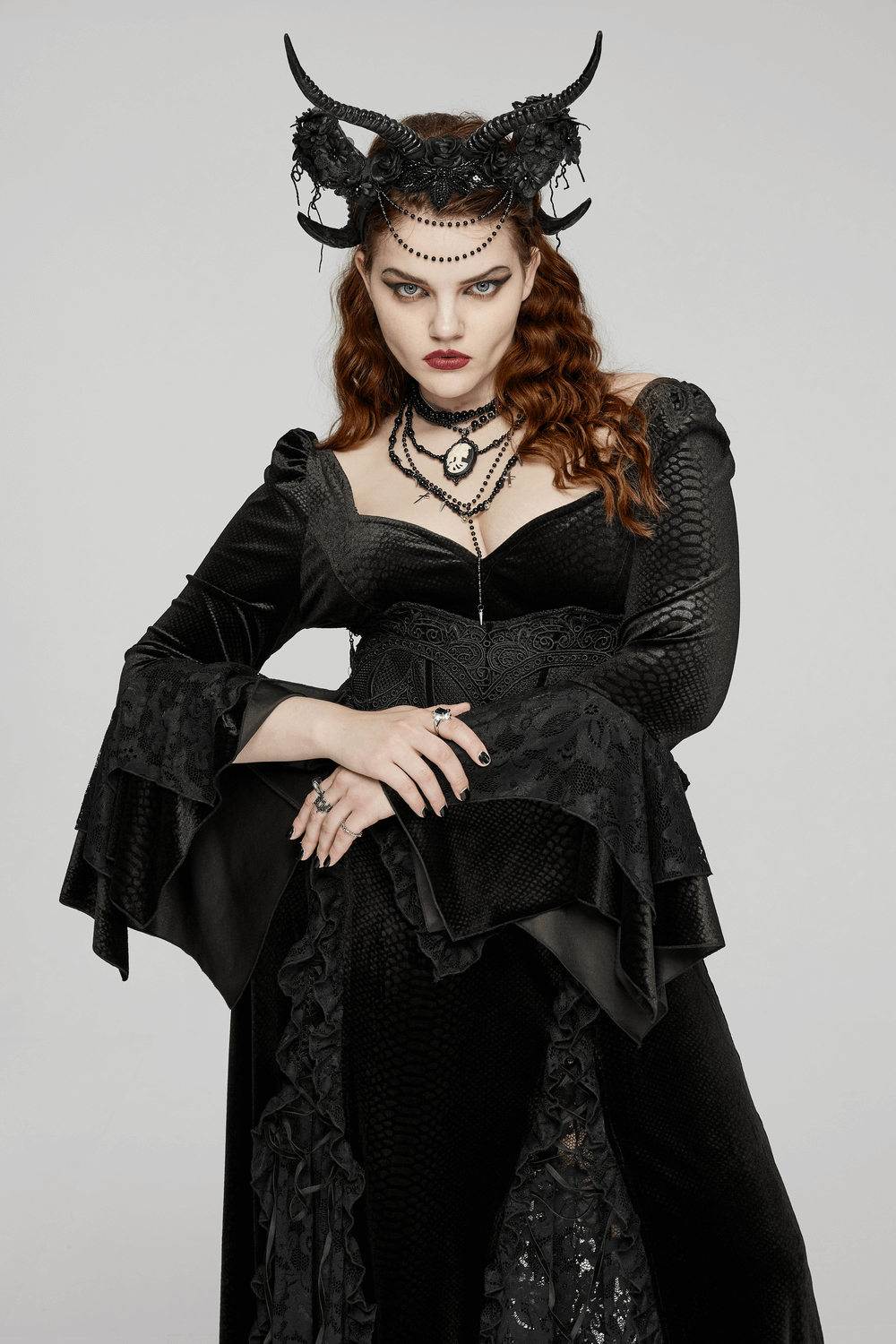 Gothic woman in black attire wearing Allure Horned Headpiece with lace detail, exuding dark elegance.