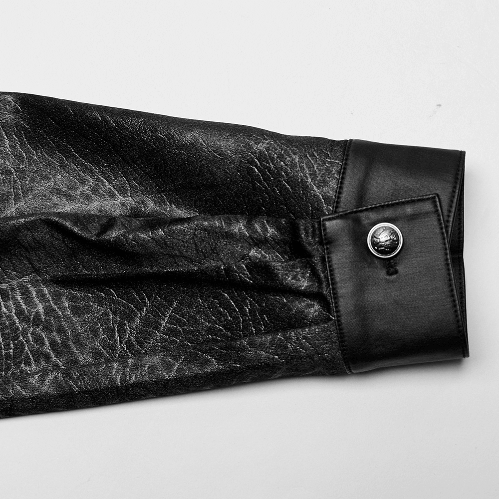 Close-up of gothic black shirt sleeve with textured fabric and stylish button detail.