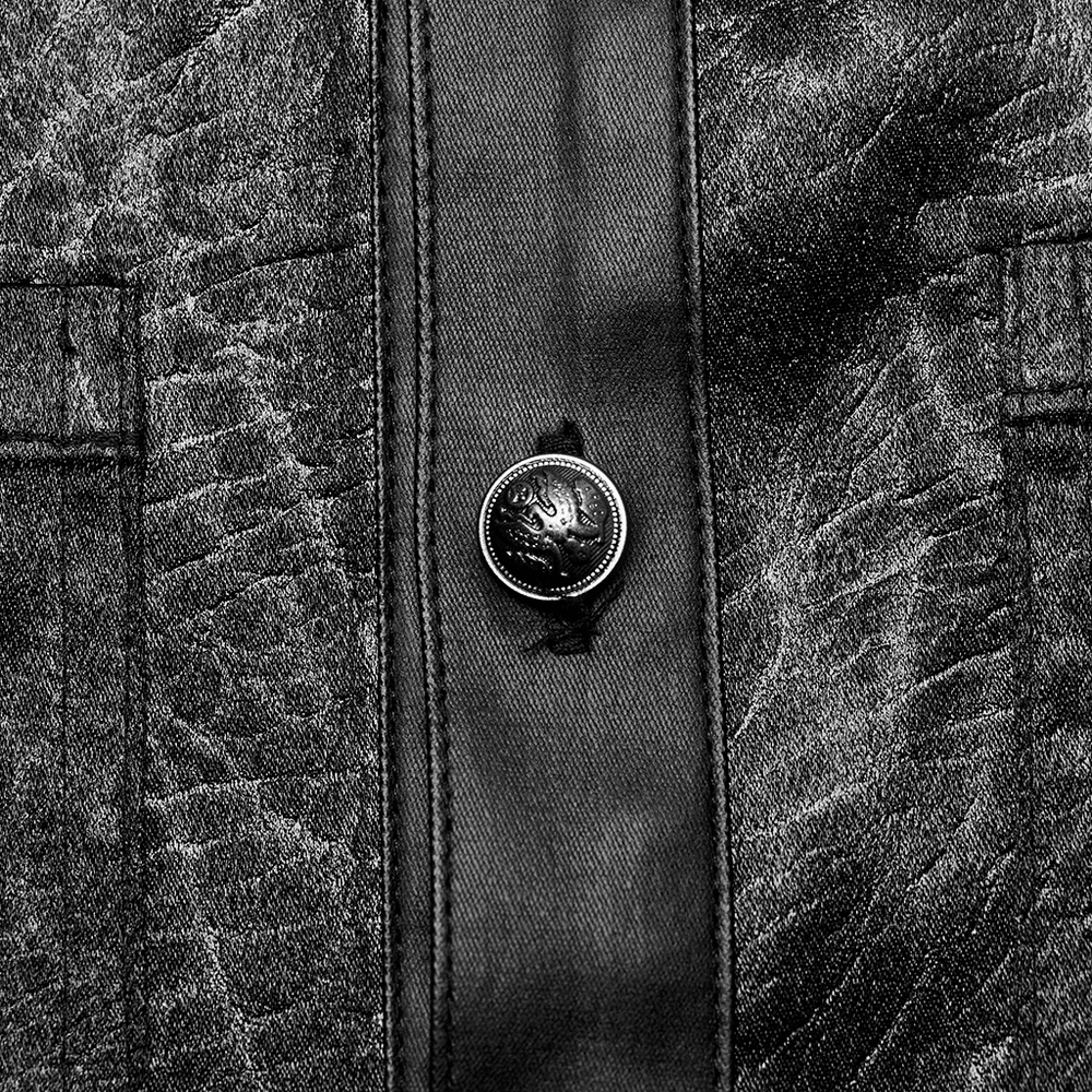 Close-up of a black shirt with splicing design and textured fabric, featuring a stylish button detail.