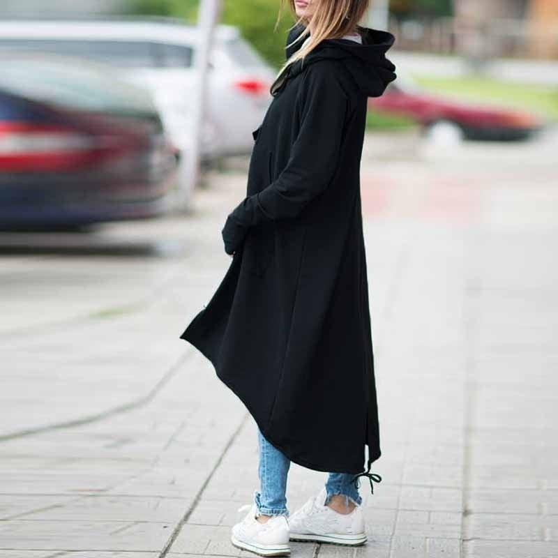 Stylish woman in a black hooded trench coat with zippers, perfect for alternative fashion lovers.