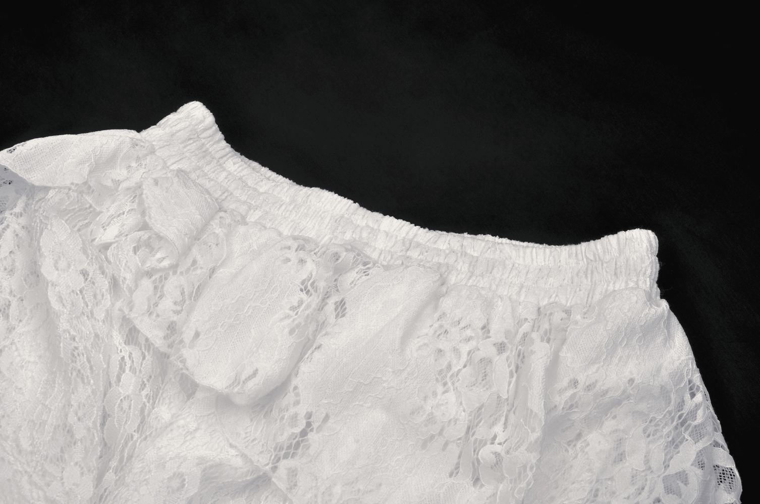 Angelic white lace mini skirt with ruffled layers, perfect for gothic night adventures and chic outings.