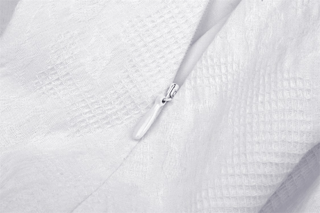 Close-up of the zipper detail on the Angelic Women's Mini Dress featuring intricate lace fabric.