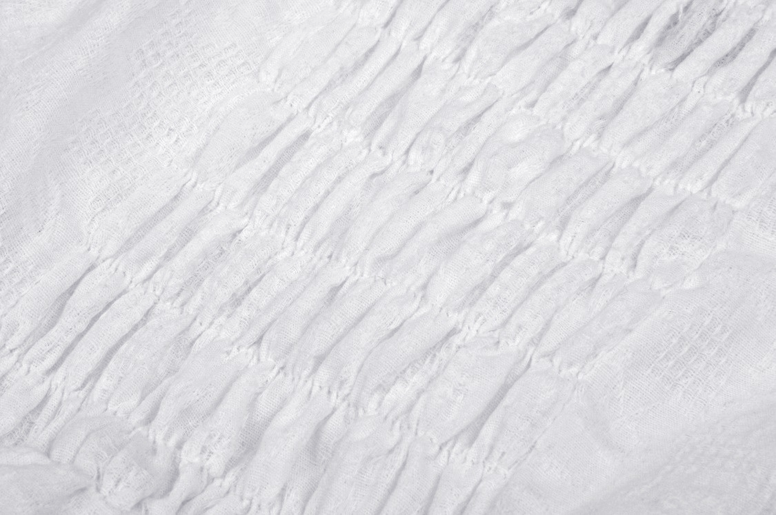 Close-up of white fabric featuring intricate smocked texture, perfect for a gothic Lolita mini dress.