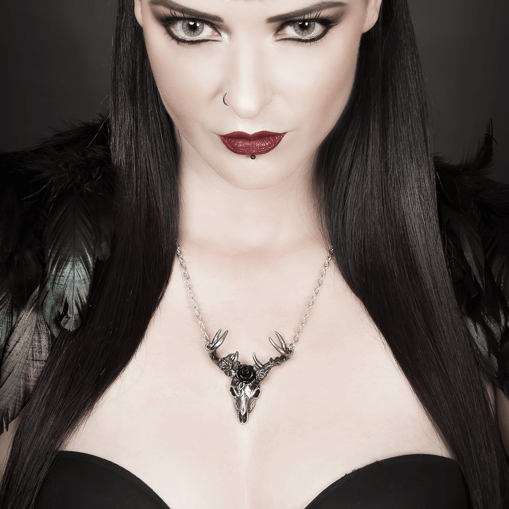 Model showcasing an antiqued pewter White Hart and Black Rose Pendant atop a dark outfit.