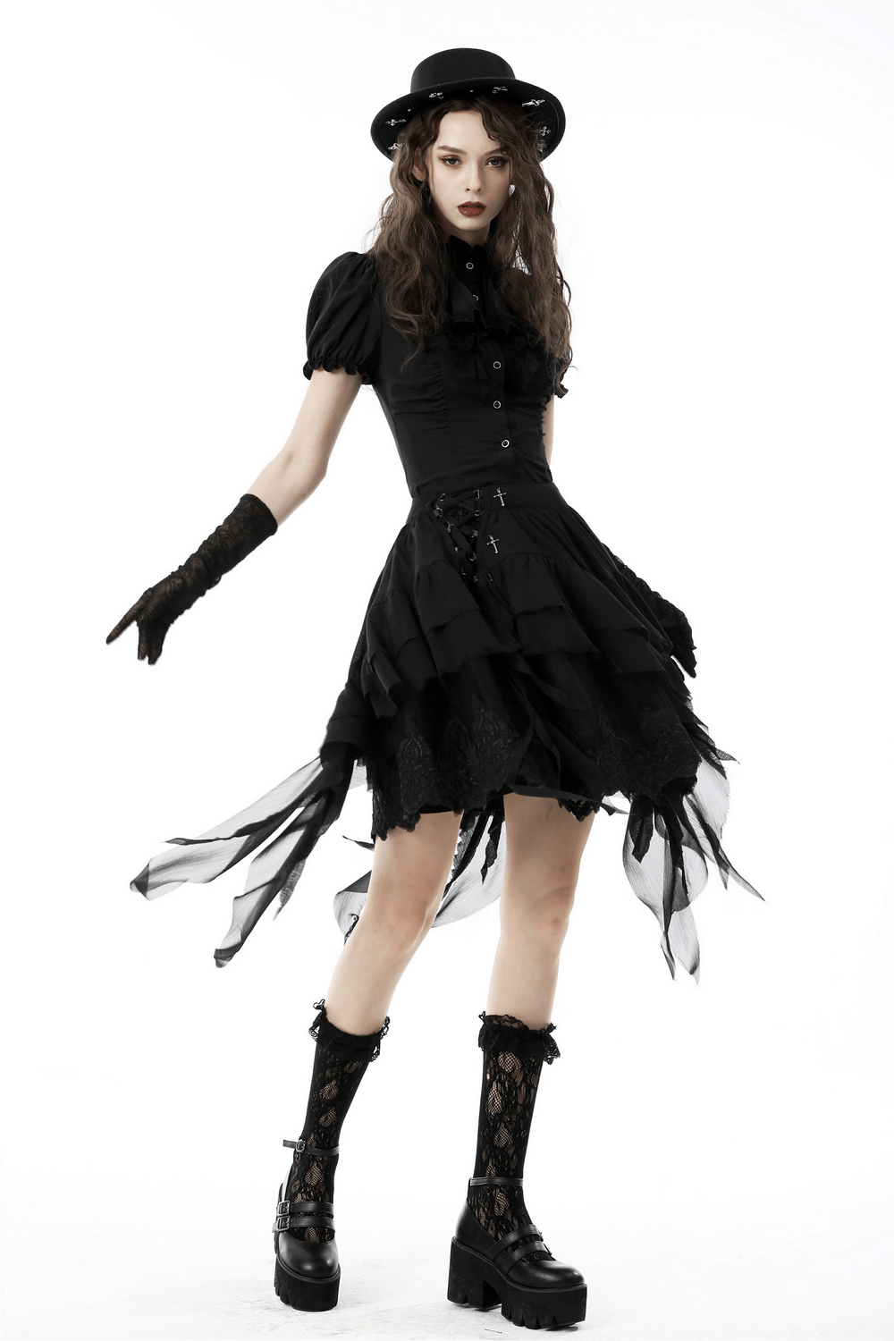 Asymmetric layered ruffle skirt styled with a gothic top hat, gloves, and platform boots for a punk festival look.