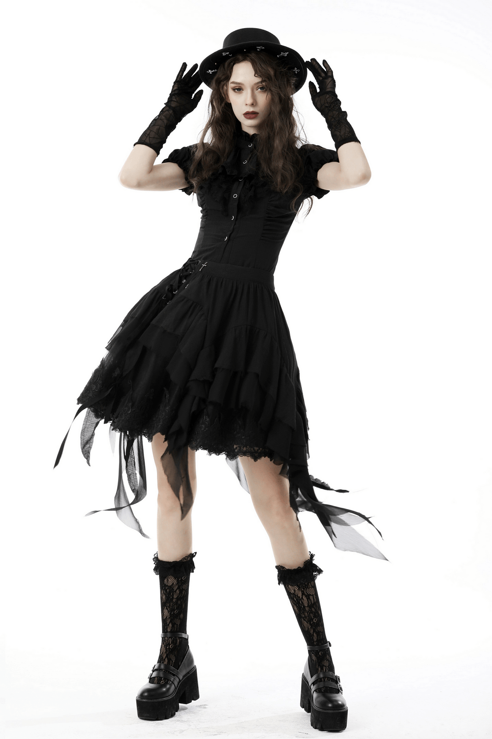 Asymmetric layered ruffle skirt styled with gothic elements for a punk or witchy festival look.