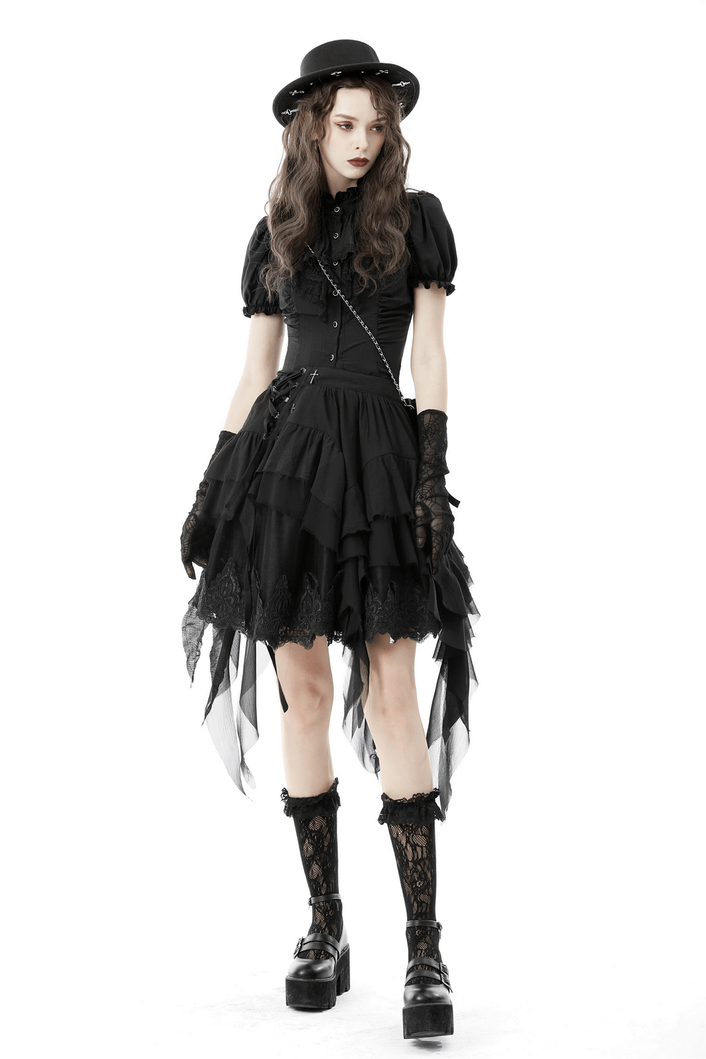 Model wearing an asymmetric layered ruffle skirt, styled with gothic accessories for a punk festival look.