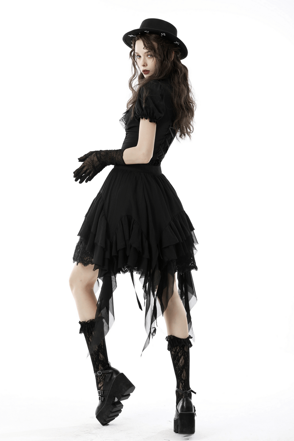 Asymmetric layered ruffle skirt styled with gloves and hat for a punk festival look. Perfect for dark fairy outfits.