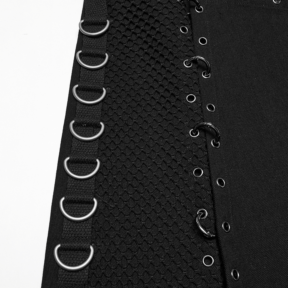 Close-up of an asymmetric male gothic skirt with metal snap accents and intricate grommet details.