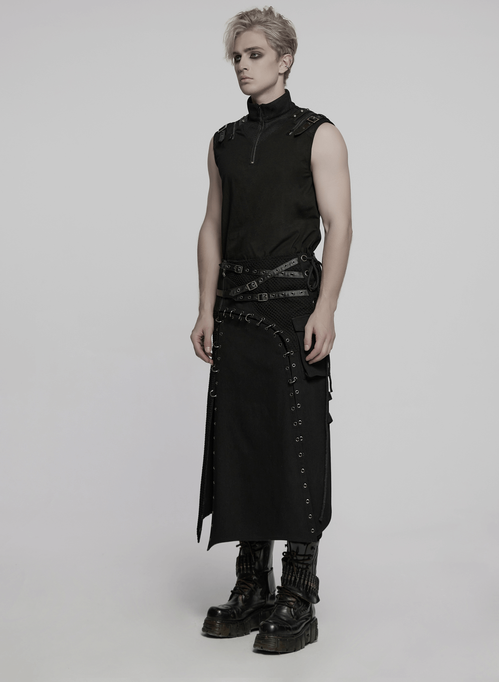 Asymmetric male gothic skirt with metal snaps, paired with a stylish black sleeveless top and chunky boots.