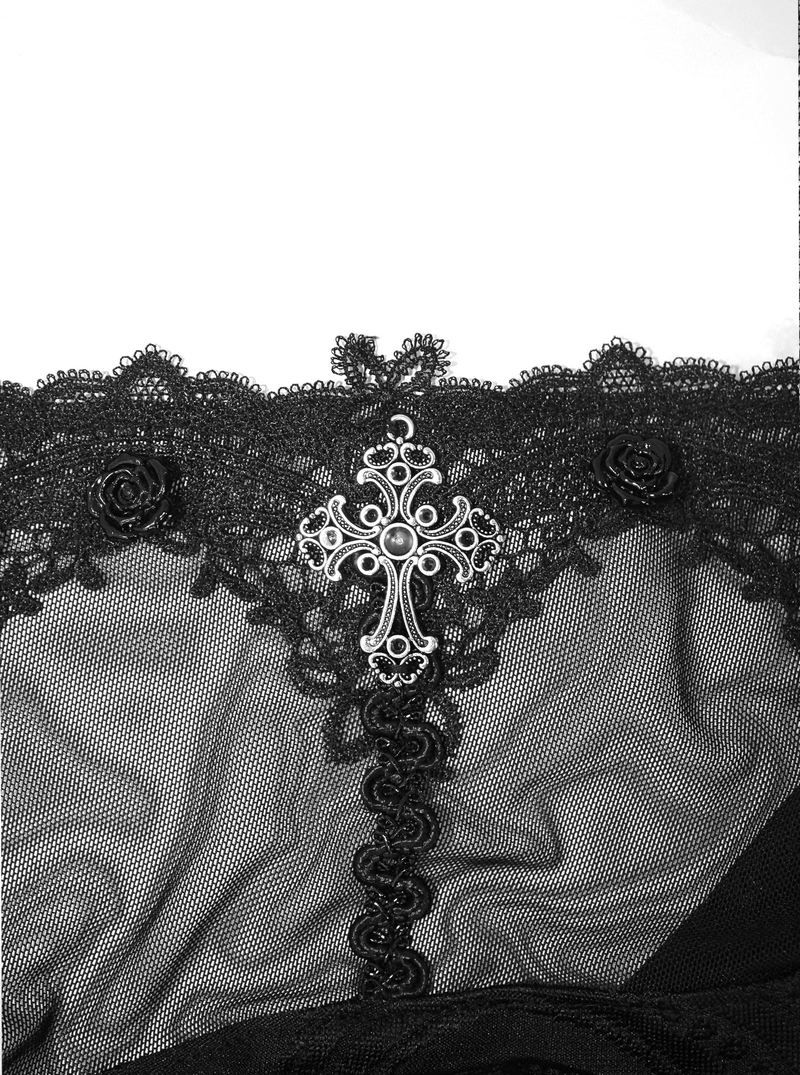 Close-up of lace detail on a Gothic dress featuring a silver cross and black roses.