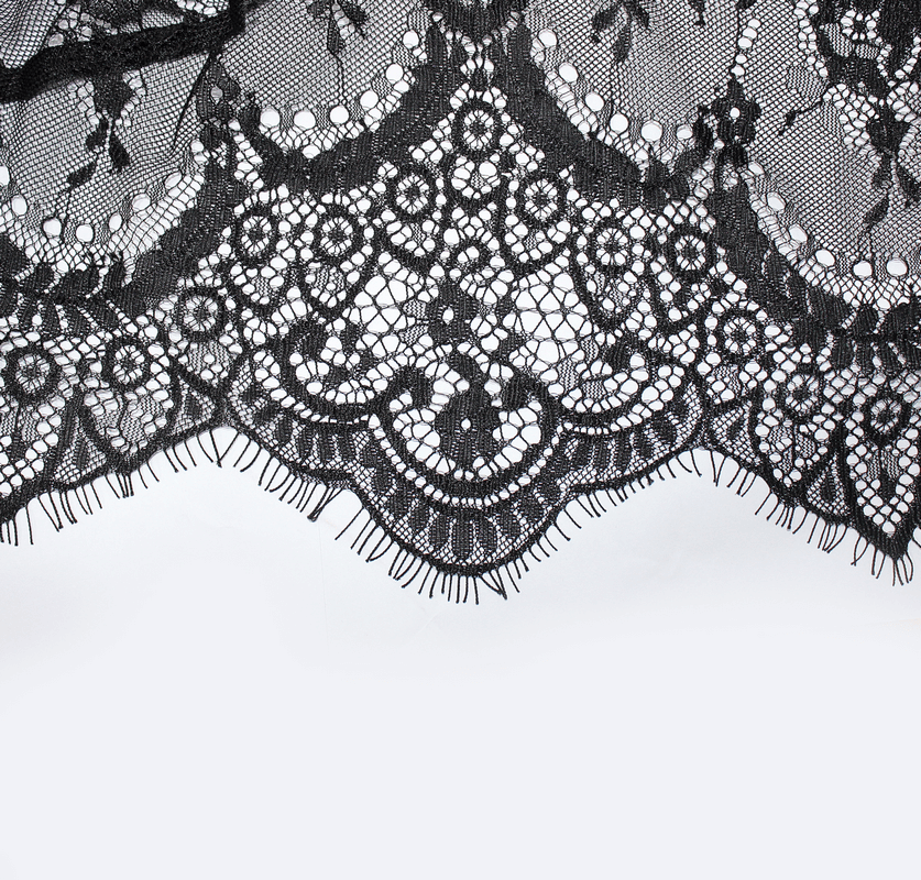 Close-up of elegant black lace featuring intricate patterns and delicate fringes, perfect for gothic fashion.