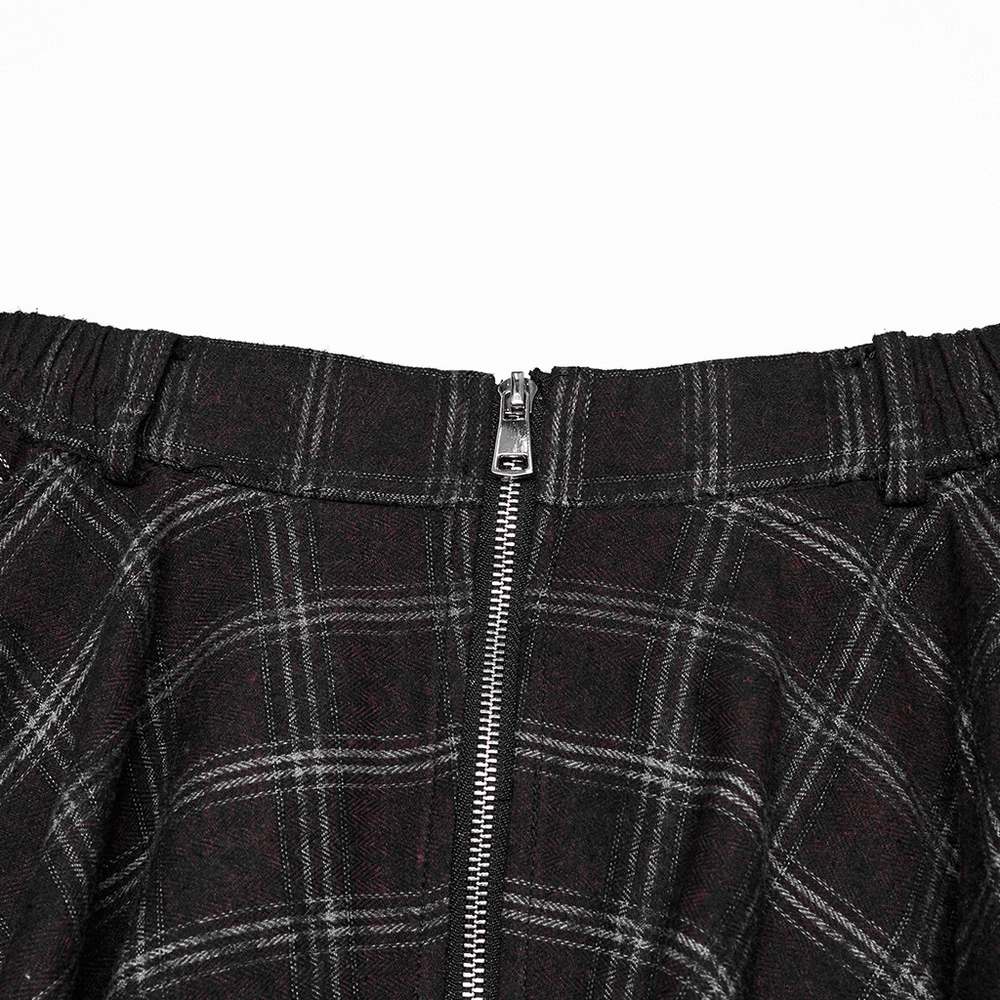 Close-up of the asymmetrical gothic plaid skirt featuring a front metal zipper and elastic waistband.