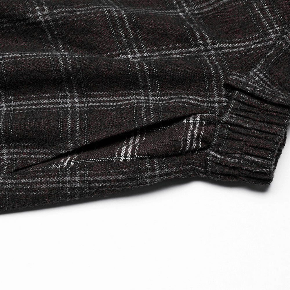 Close-up of plaid fabric showcasing the asymmetrical design and zipper of a Gothic punk skirt.