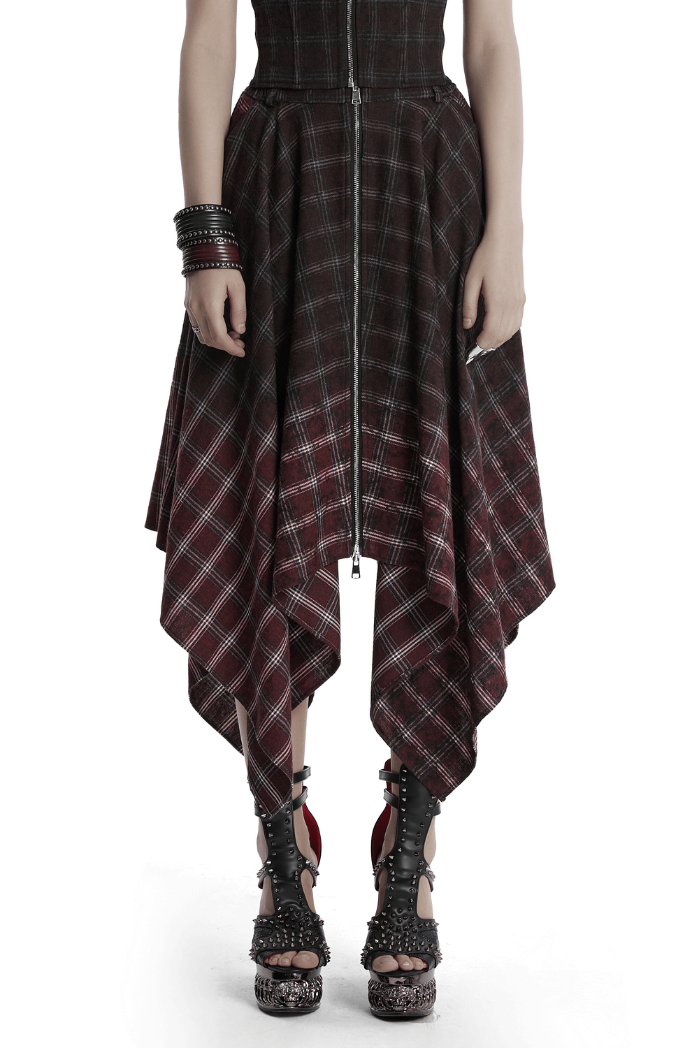 Asymmetrical Gothic plaid skirt with zipper front, featuring a punk gradient pattern and irregular hem, styled with edgy heels.