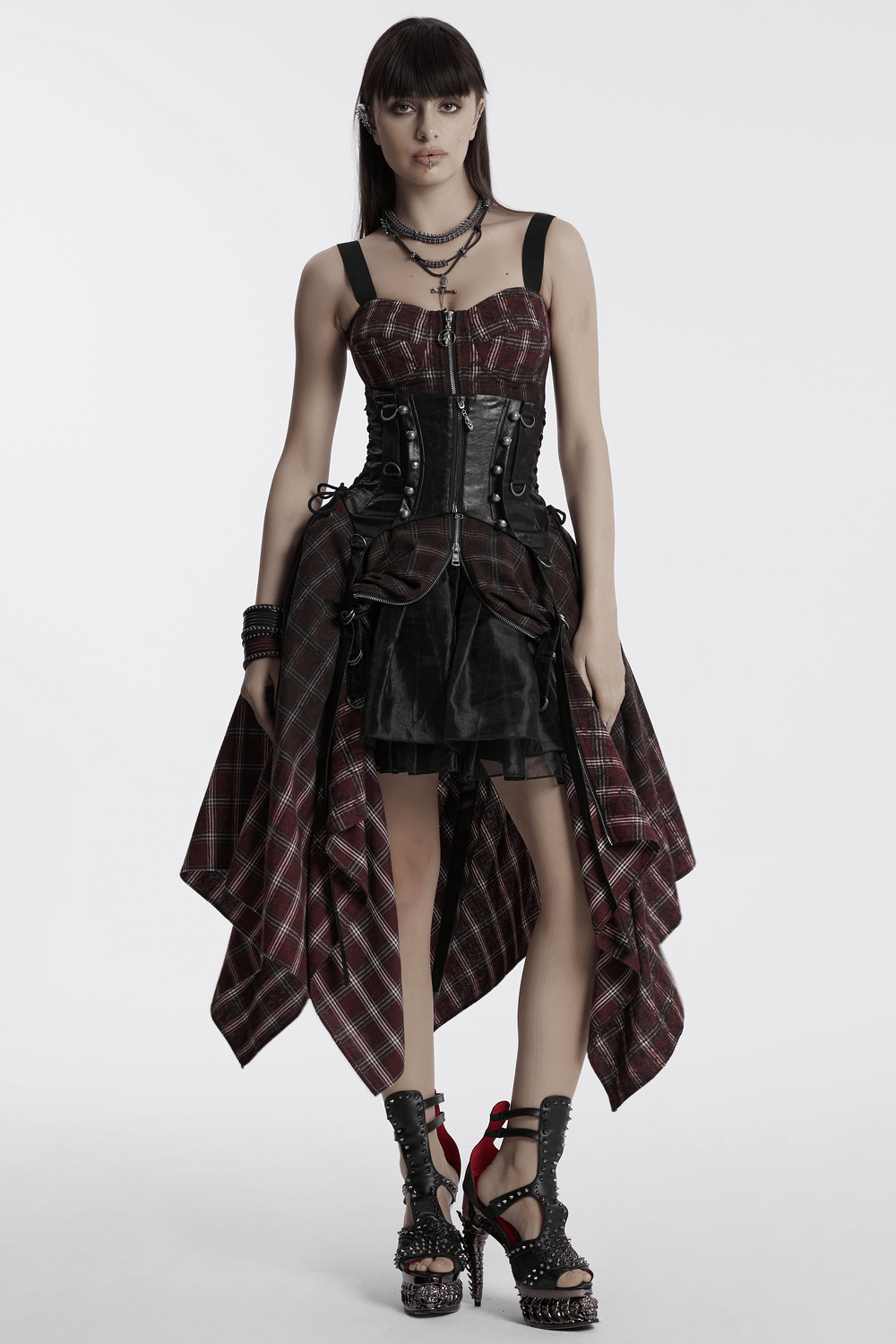 Model wearing an asymmetrical gothic plaid skirt with zipper front, showcasing punk style and edgy fashion.