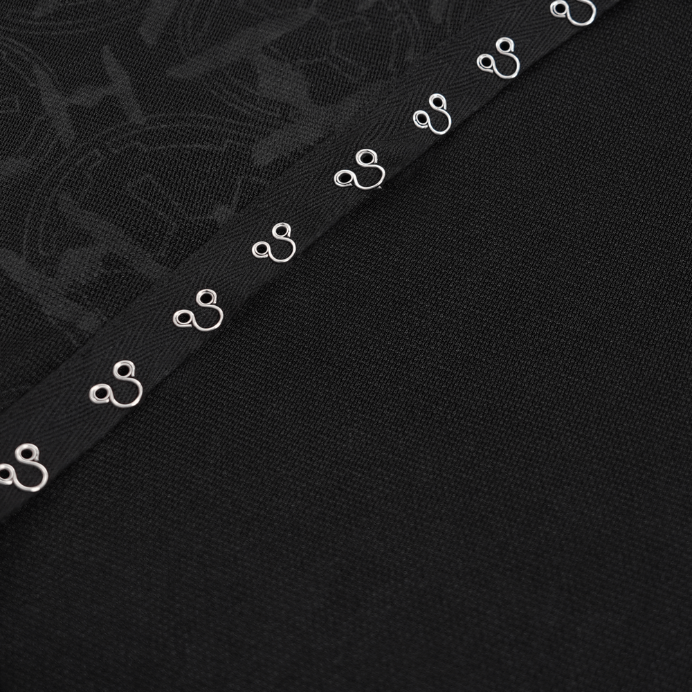 Close-up of intricate lace and metal accents on a black asymmetrical gothic long-sleeve top.