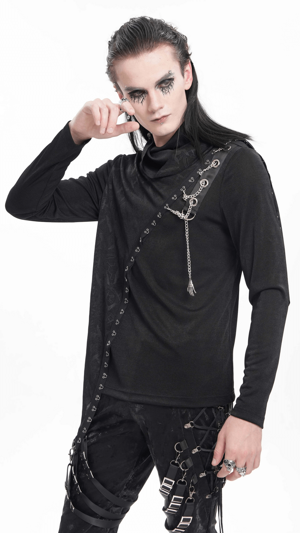 Dark punk model showcasing asymmetrical gothic top with chain and lace accents for a bold, edgy look.