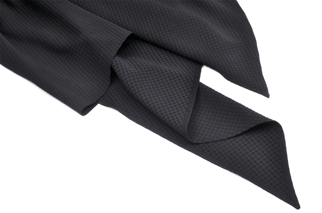 Close-up of dramatic black fabric with a textured pattern, perfect for elegant dress designs.