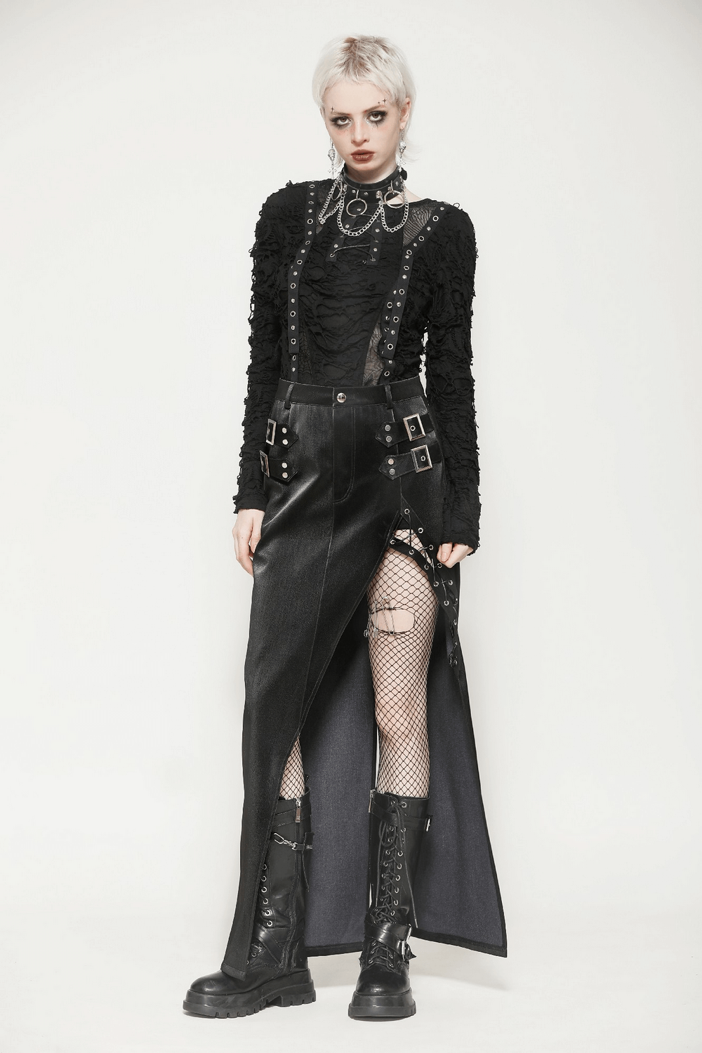 Edgy high-waisted asymmetrical PU leather skirt with buckles and lacing, paired with a black ruffled top and fishnet stockings.