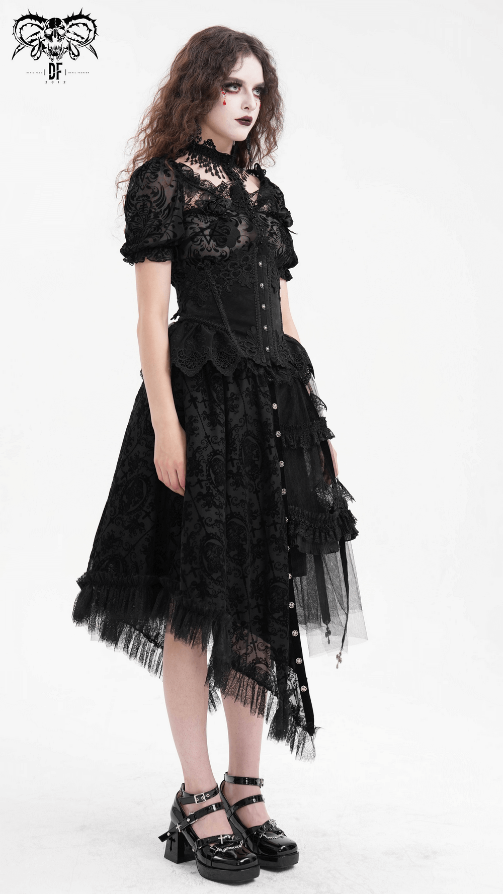 Elegant model in asymmetrical gothic skirt with bat wing accents and lace details.