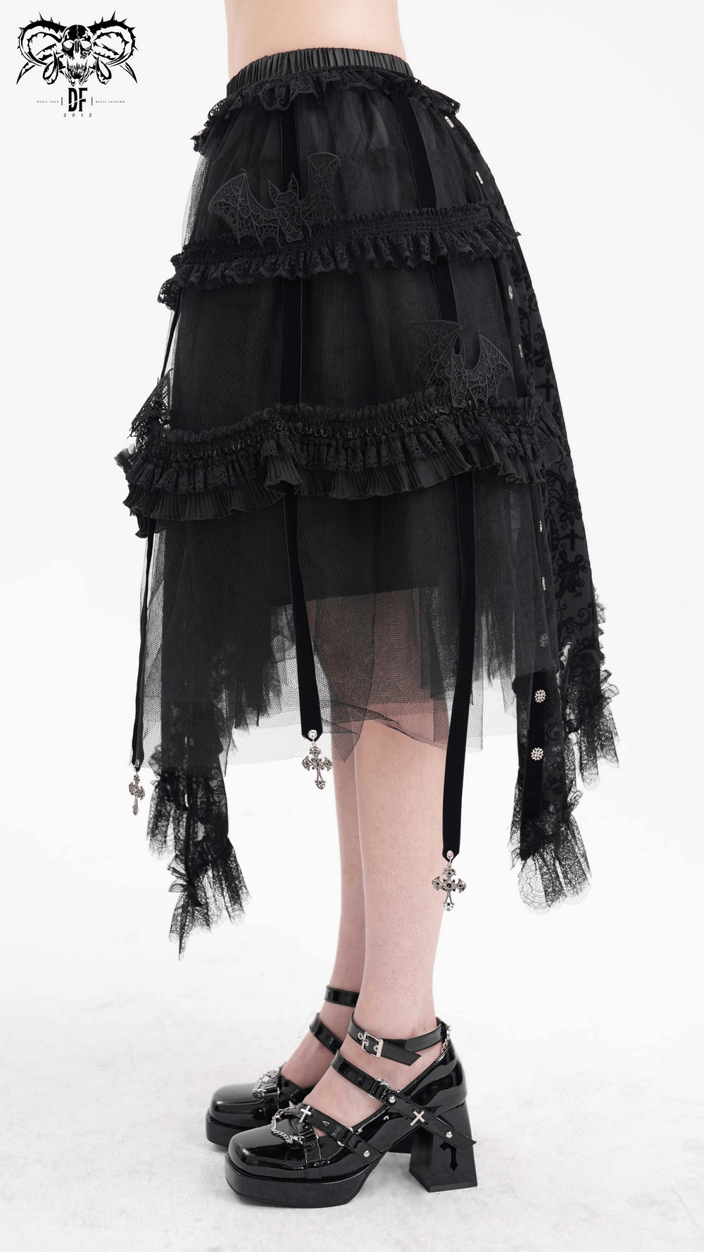 Elegant asymmetrical black skirt with bat wing accents, ruffles, and cross charms, perfect for gothic fashion.