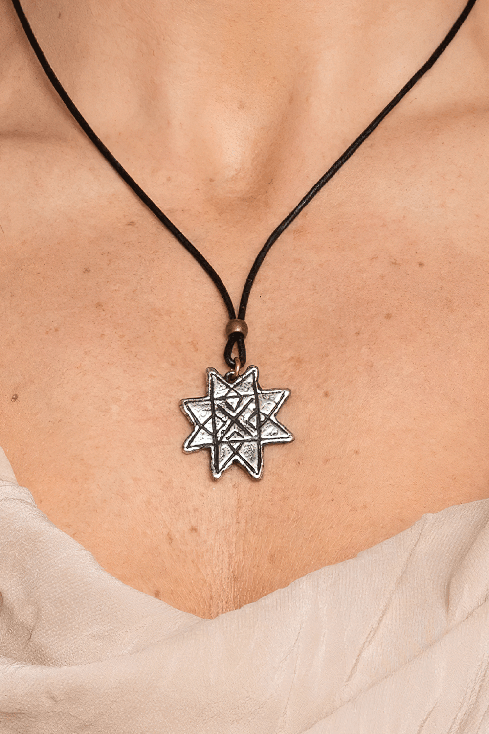 Auseklis Pewter Amulet Gothic Protection Necklace showcased on a model, highlighting its intricate star design.