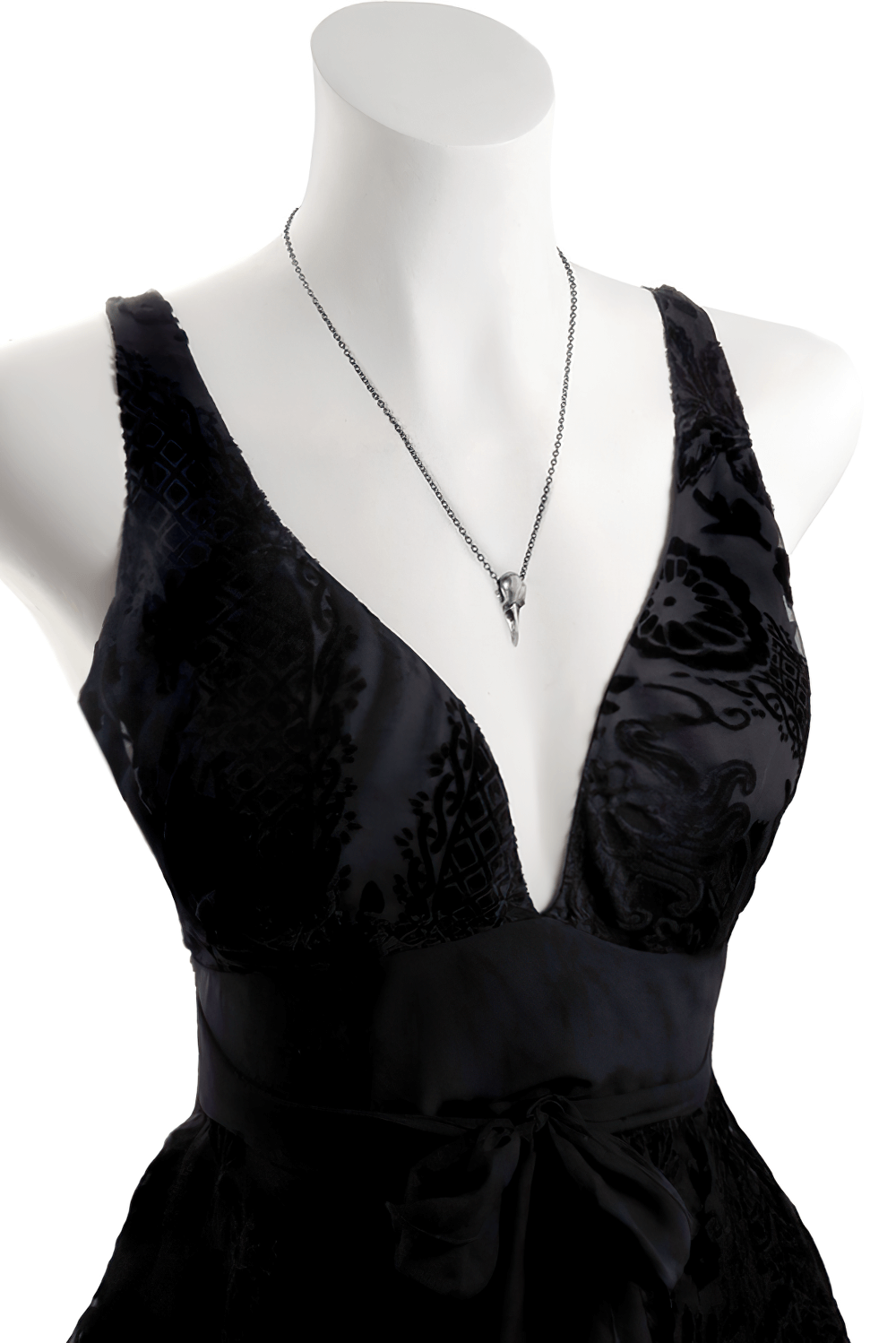 Stylish black dress on a mannequin featuring an authentic raven skull pendant necklace.
