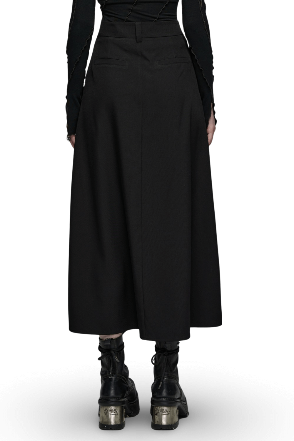 Back view of avant-garde asymmetric draped skirt with buckle detail, styled with edgy ankle boots.