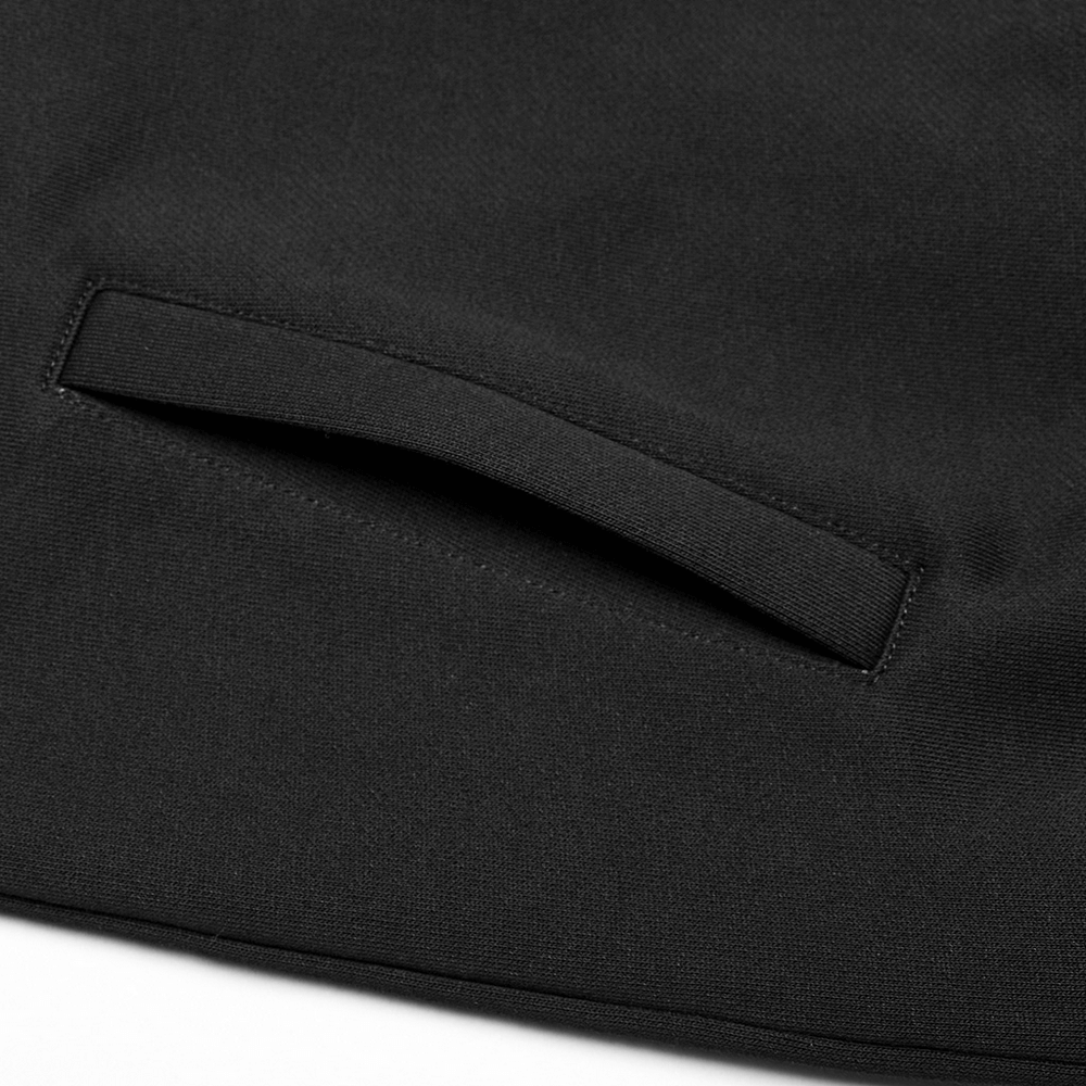 Close-up of the avant-garde black hoodie showing the sleek pocket design with faux leather accents.