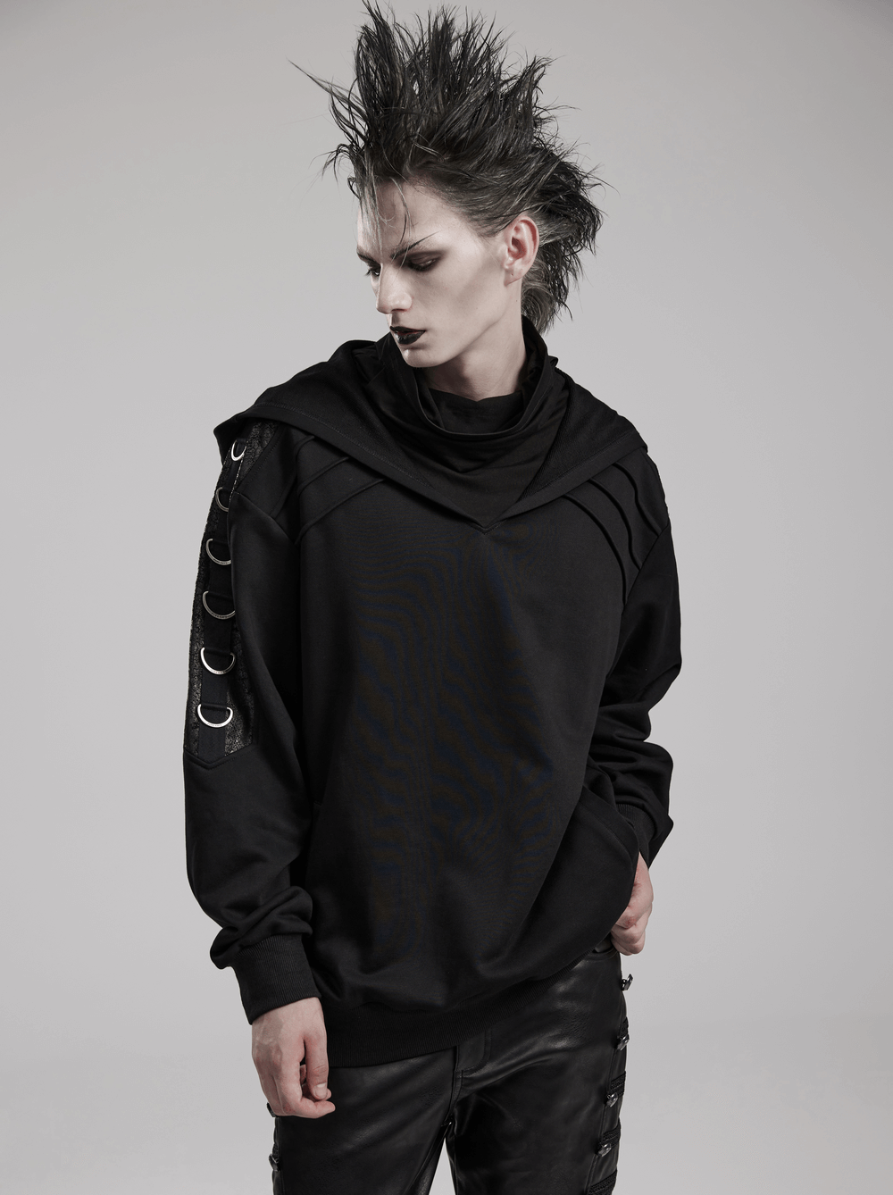 Edgy black hoodie with faux leather details and D-Ring accents, perfect for a punk-inspired look.