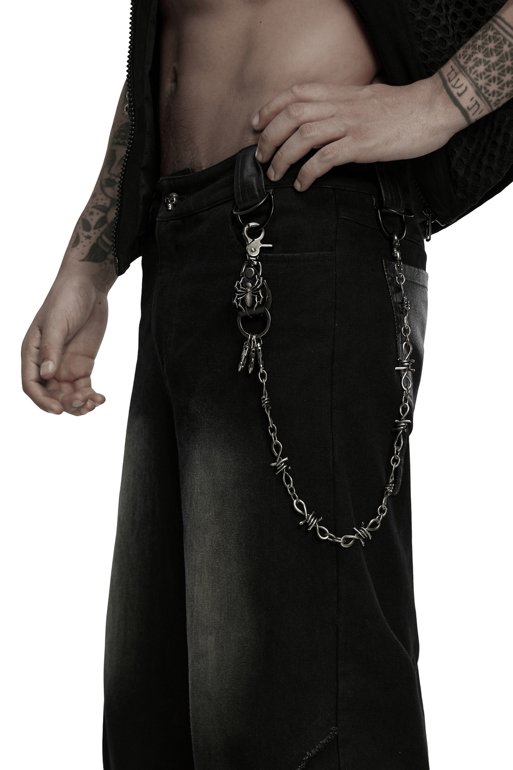Punk spider keychain clip on a retro barbed wire chain, adding edgy style to casual black jeans.