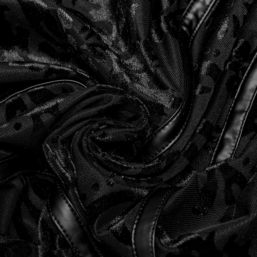 Close-up of black flocked gauze fabric, showcasing ornate texture and faux leather detailing for gothic style.