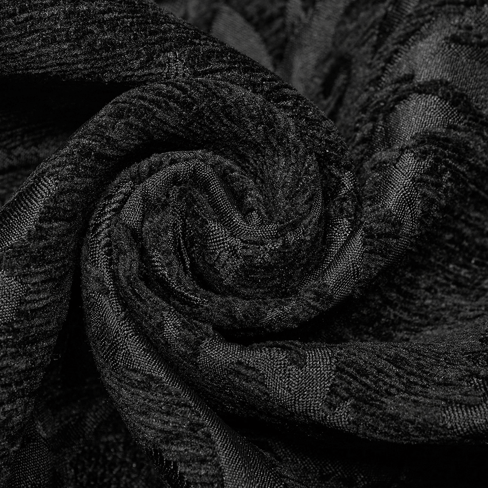 Close-up of black jacquard fabric, showcasing intricate patterns for a Baroque Gothic waistcoat.