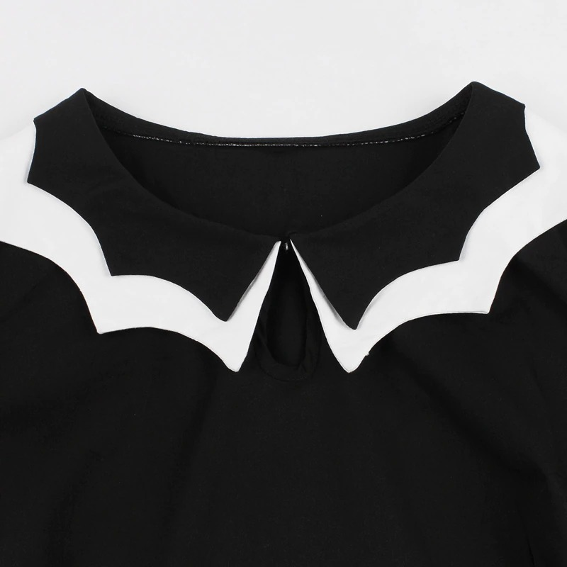Close-up of the collar detail on a black women's gothic dress with a unique white collar design.