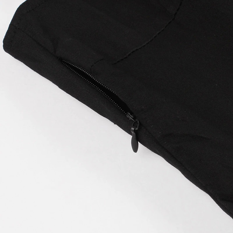 Close-up of zipper detail on a black dress, showcasing modern gothic style for Halloween.