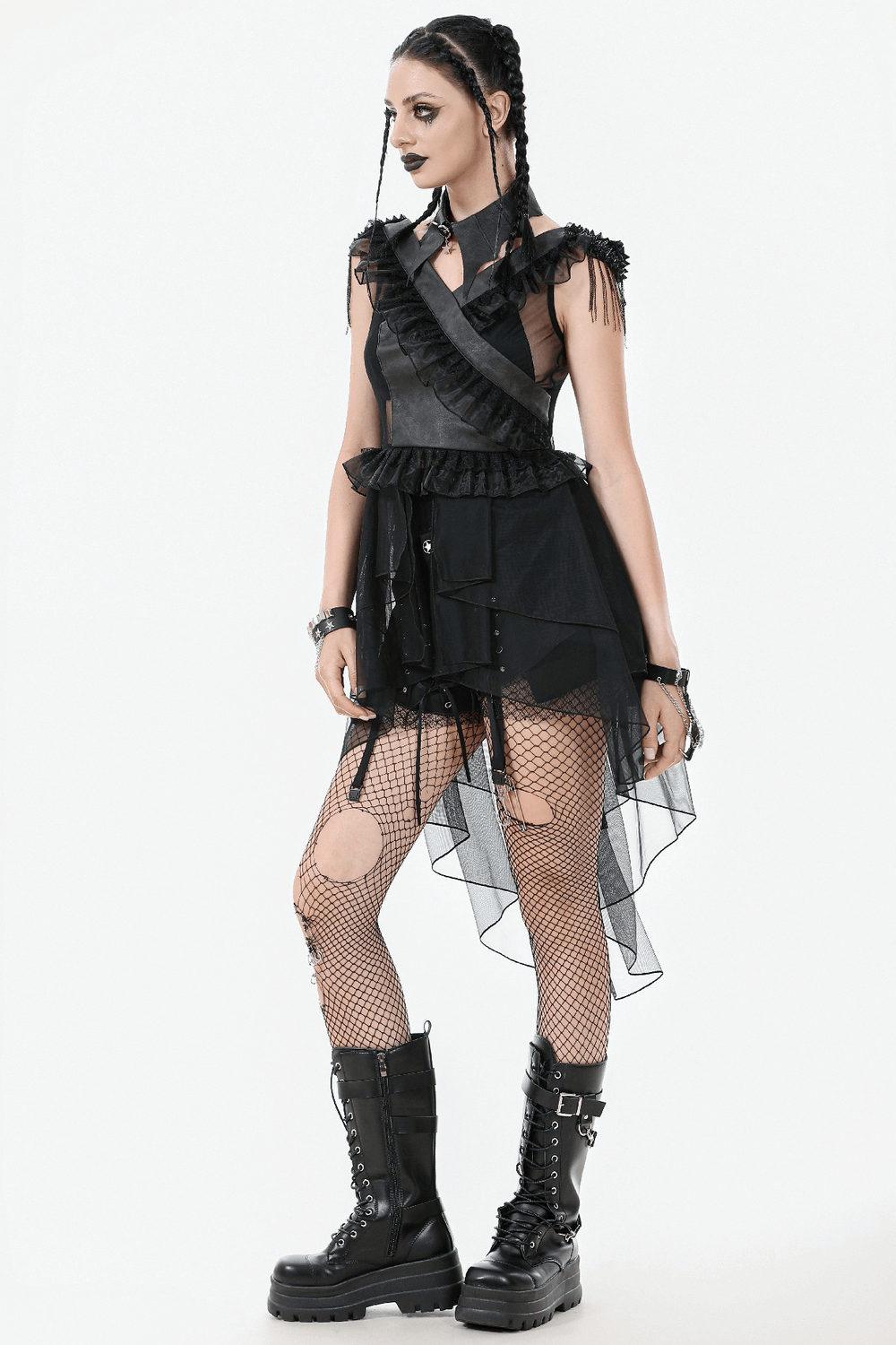 Alternative goth outfit featuring frilly black dress, fishnet tights, and chunky combat boots for a punk-inspired look.